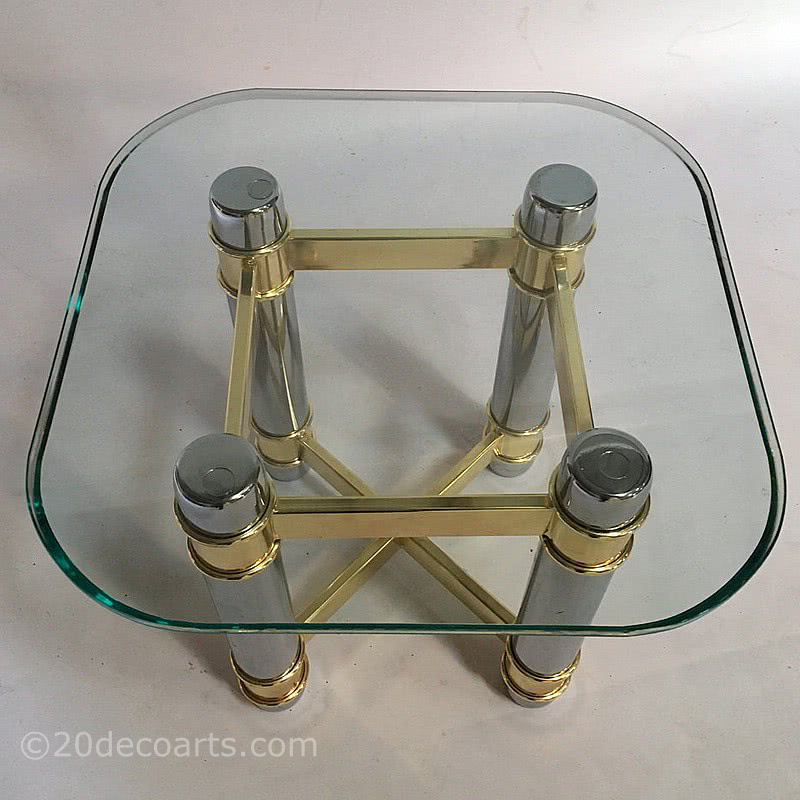  20th Century Decorative Arts |A side table, the glass top supported on a brass and chrome plated metal base, circa last quarter of the 20th century, very much in the Hollywood Regency style. 