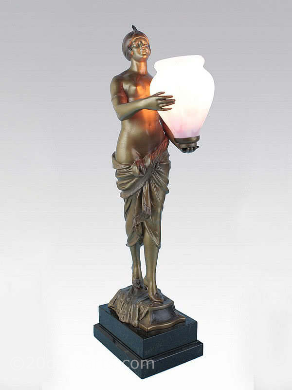  20th Century Decorative Arts | A rare art deco spelter figure lamp, circa 1930, Germany, the spelter cold-painted in shades of gold, mounted on a stepped granite base holding aloft a Czech glass urn shade