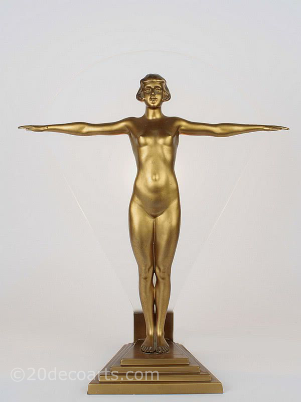  20th Century Decorative Arts |A very stylish and rare art deco figure spelter lady lamp, circa 1930, Germany, the cold-painted gold figure stood on a stepped base in front of satin finish glass