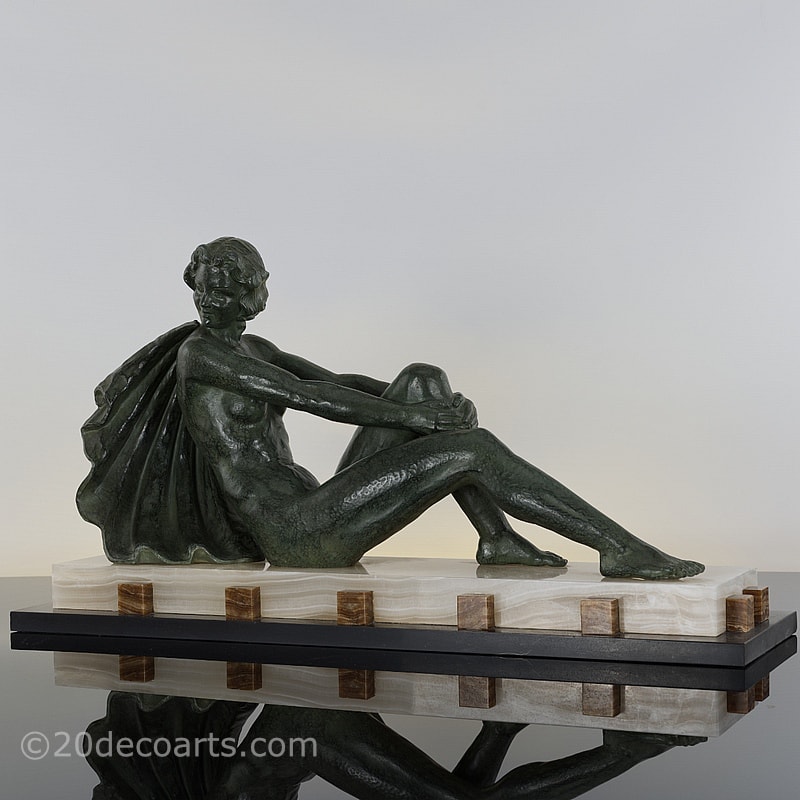   Art Deco spelter figure by Ugo Cipriani, the antiqued green finish stylish figure on a dramatic marble and onyx base 